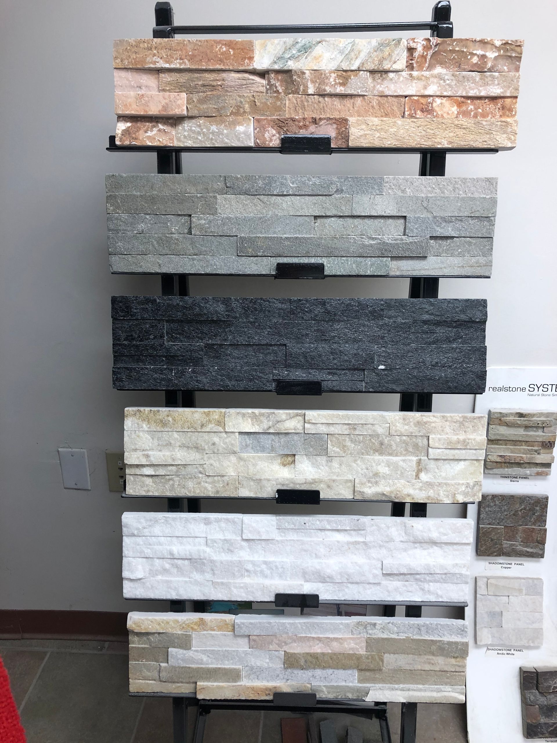 A display of different types of stone on a rack