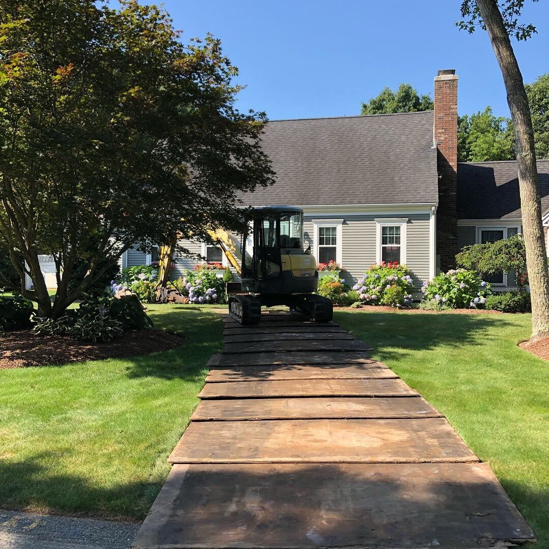 A house with a tractor parked in front of it