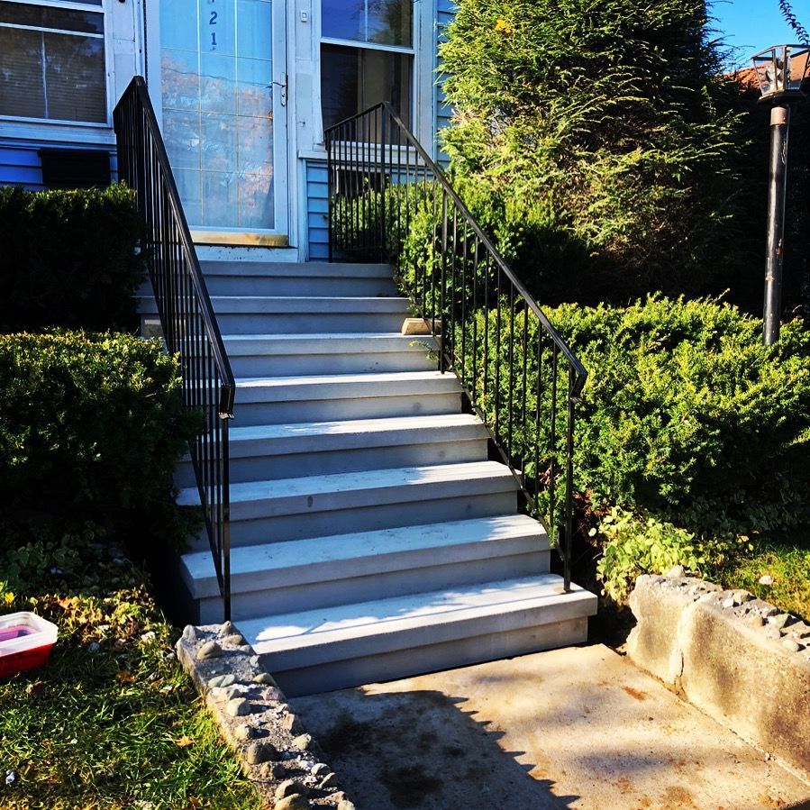 A set of stairs leading up to the front door of a house