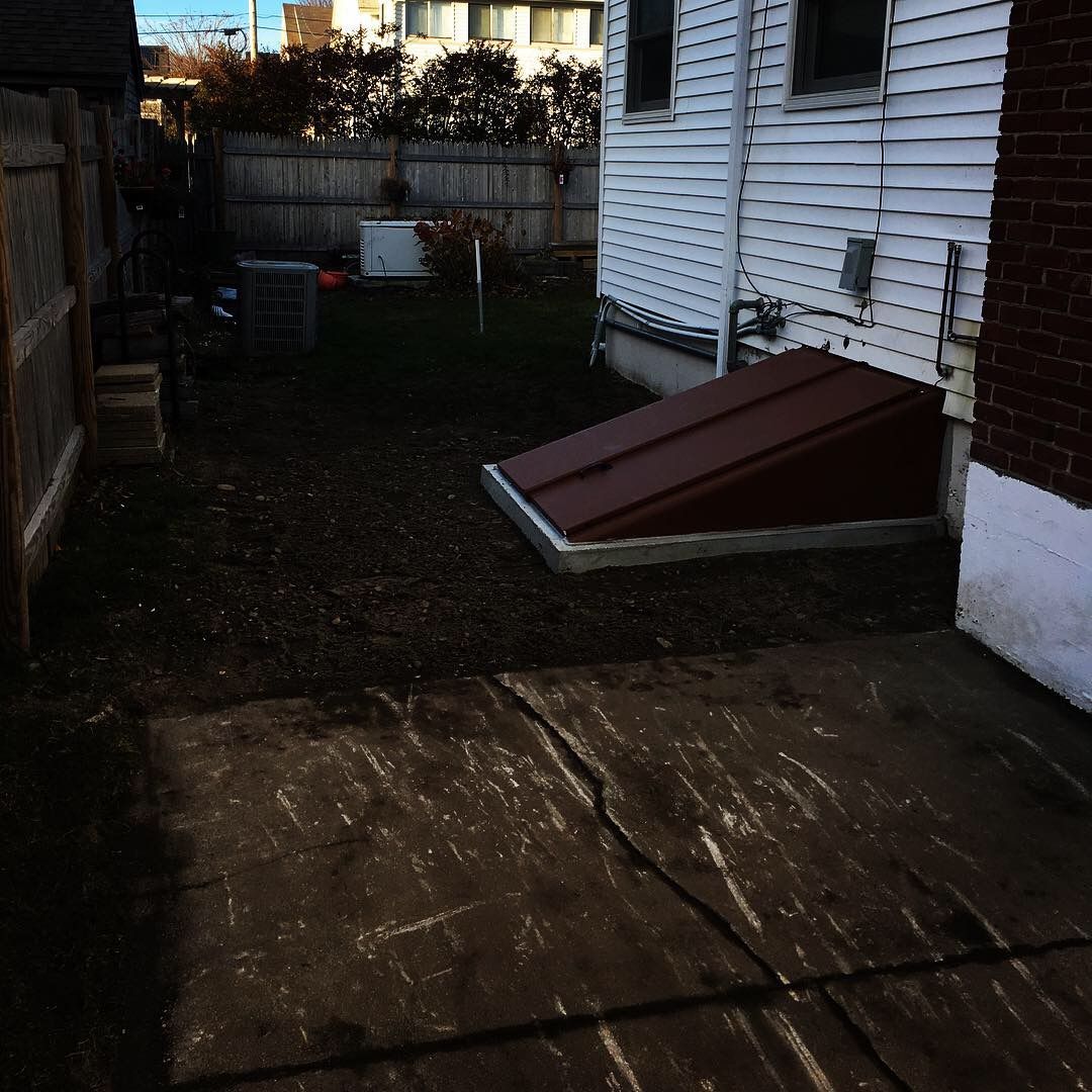 The backyard of a house with a red roof