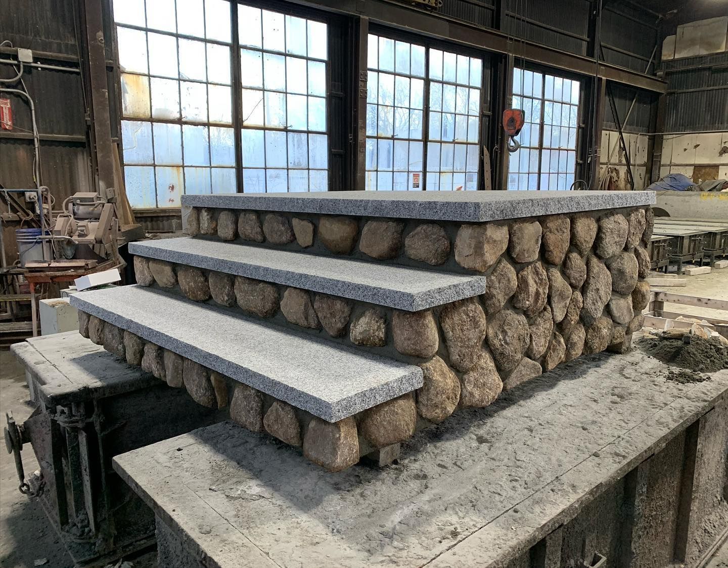 A stone staircase is being built in a factory.