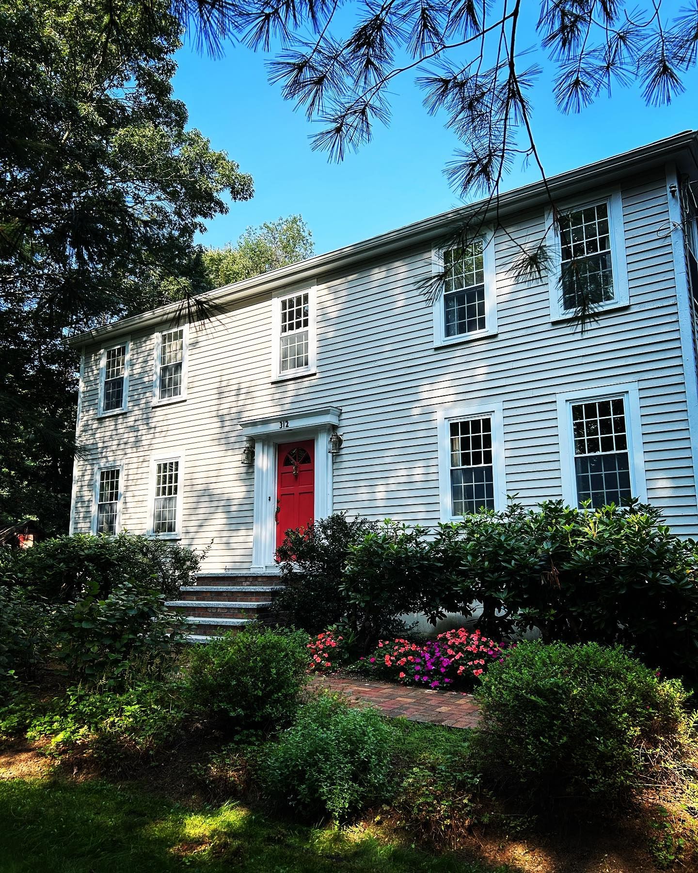 A large white house with a red door