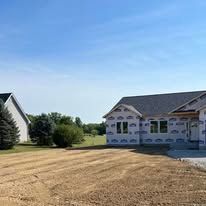 A house is being built in the middle of a field.