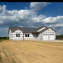 A house is being built in a dirt field.