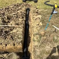 A person is digging a hole in the ground with a shovel.