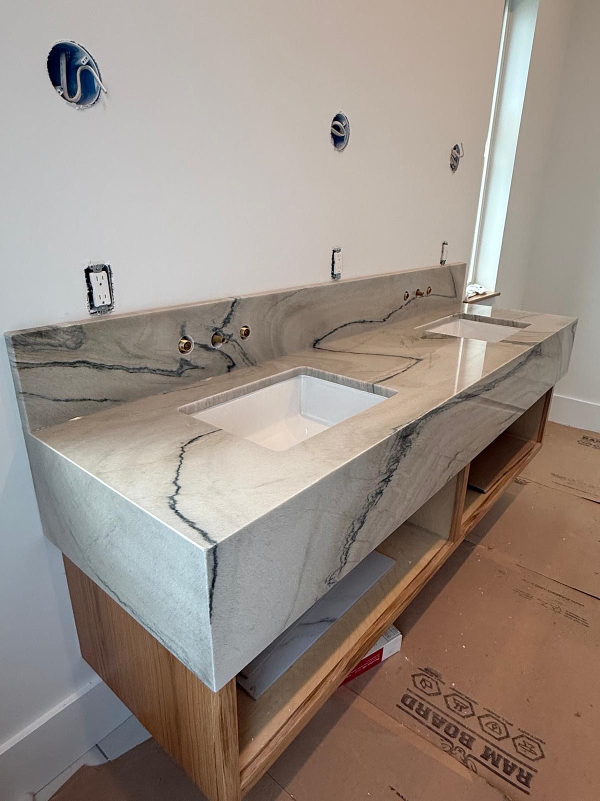 Bathroom vanity with double sinks and stone countertop under installation