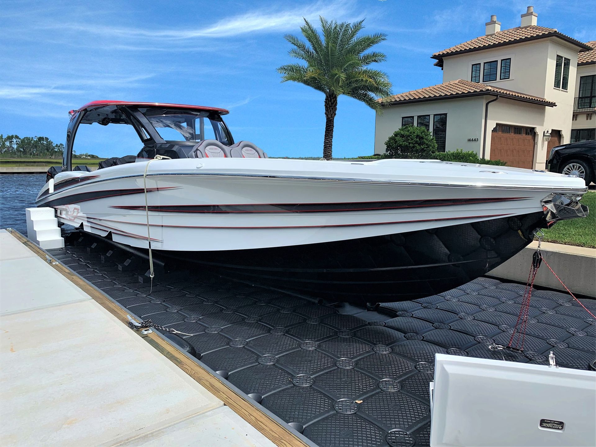 A boat is docked at a dock in front of a house.