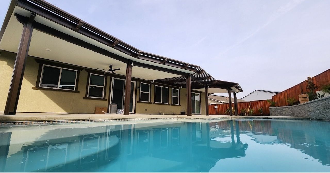 A house with a swimming pool in front of it