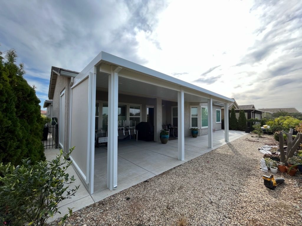 A house with a large covered patio in the backyard.