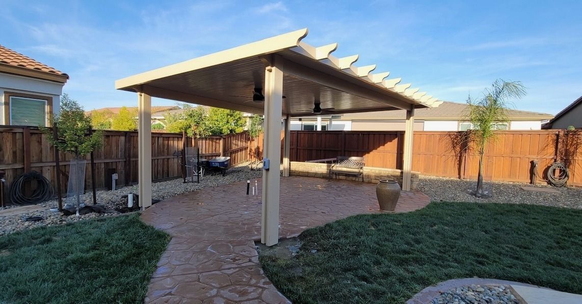 There is a pergola in the backyard of a house.