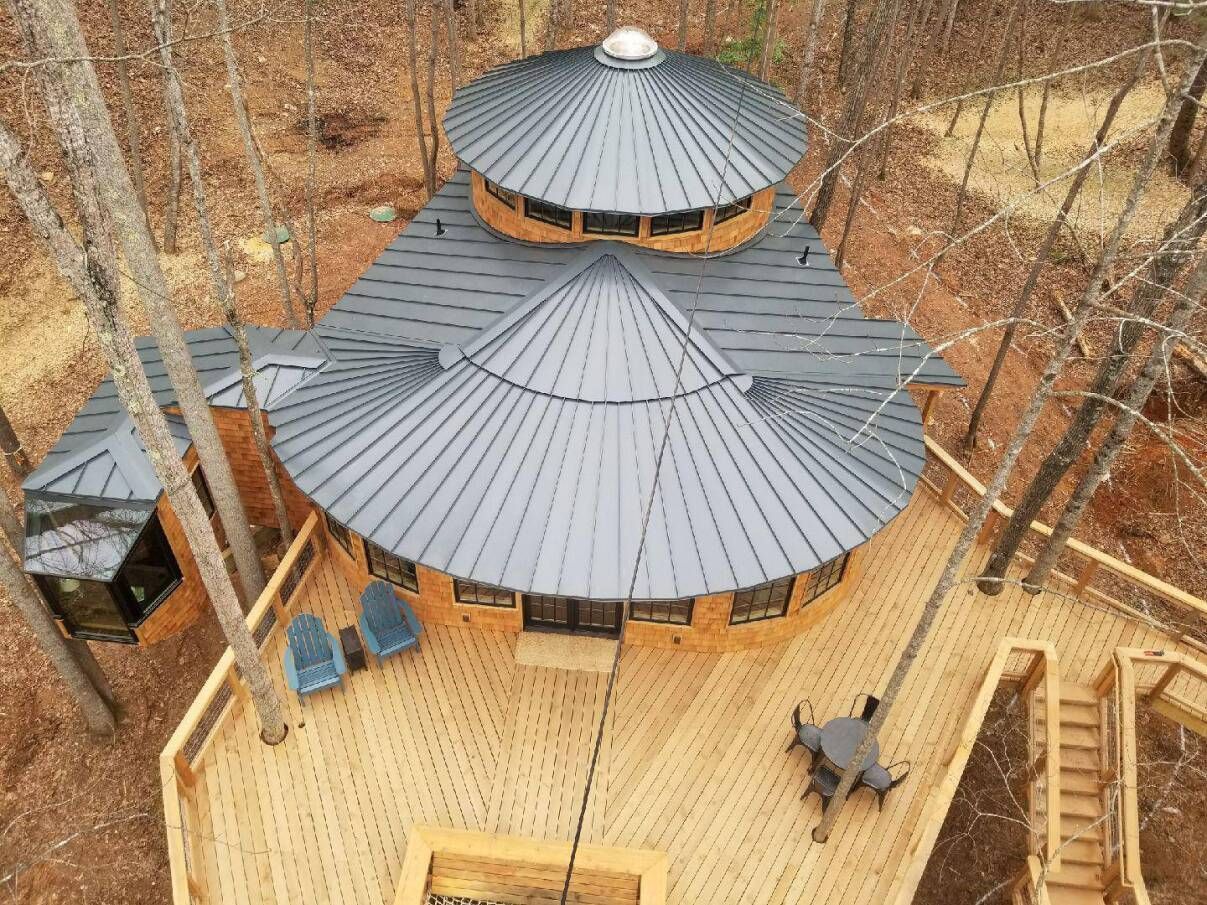 an aerial view of a tree house in the middle of a forest .