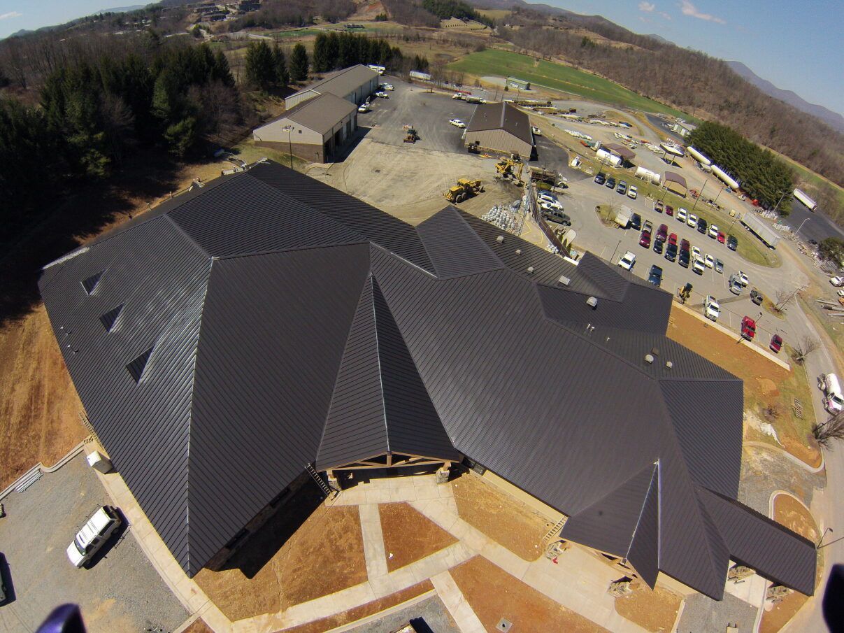 an aerial view of a large building with a black roof