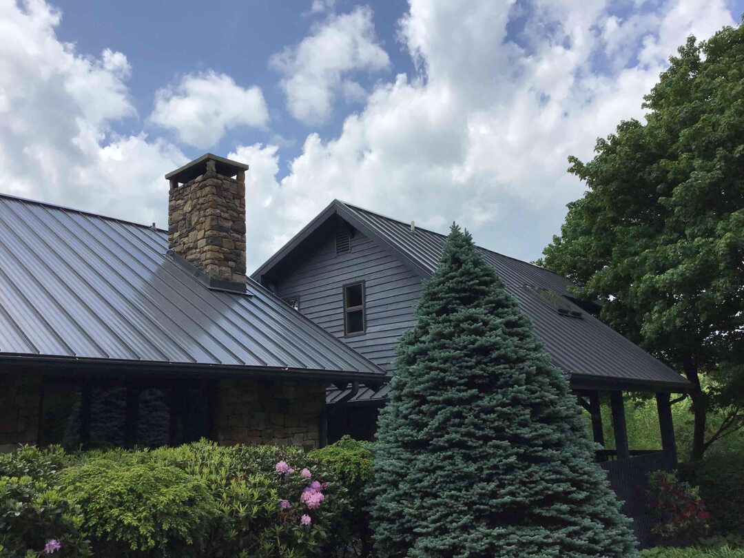 a large house with a metal roof and a chimney .
