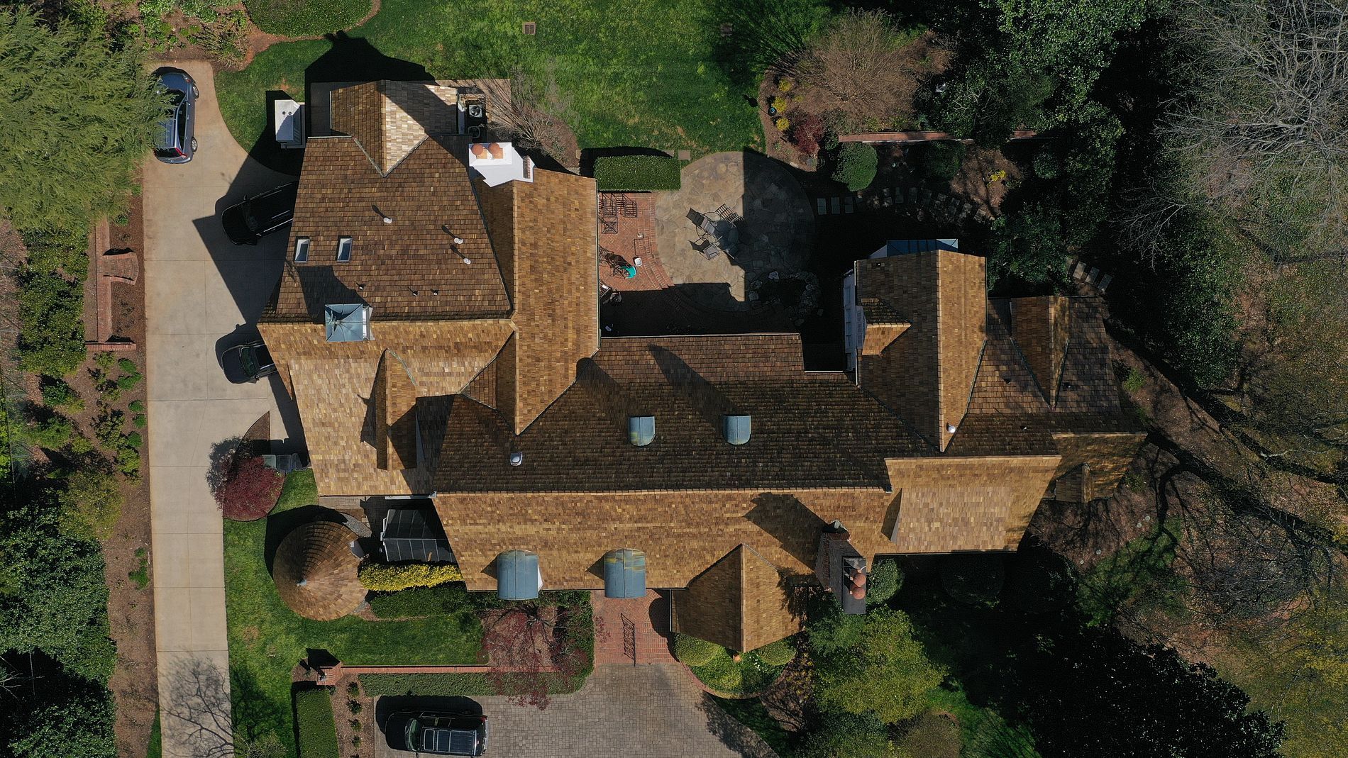 An aerial view of a large house with a wooden roof