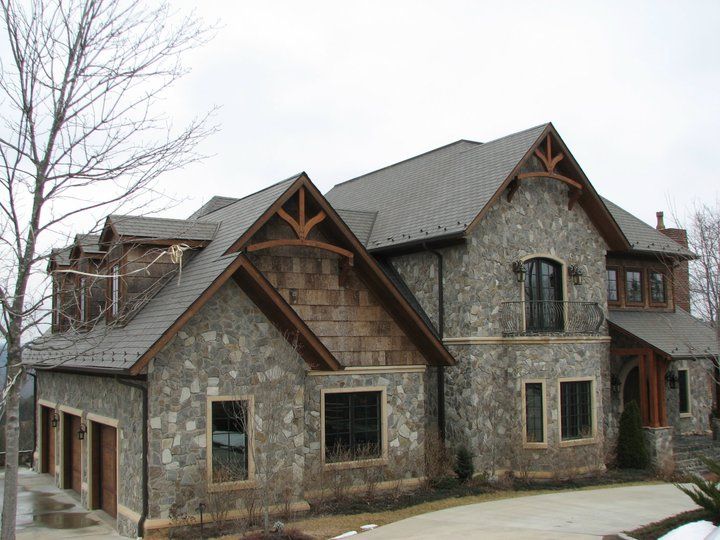 Stoned wall house with shingle roofing