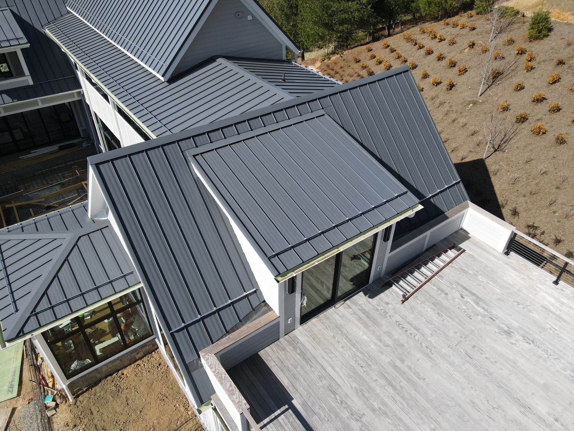 An aerial view of a large house with a gray roof.