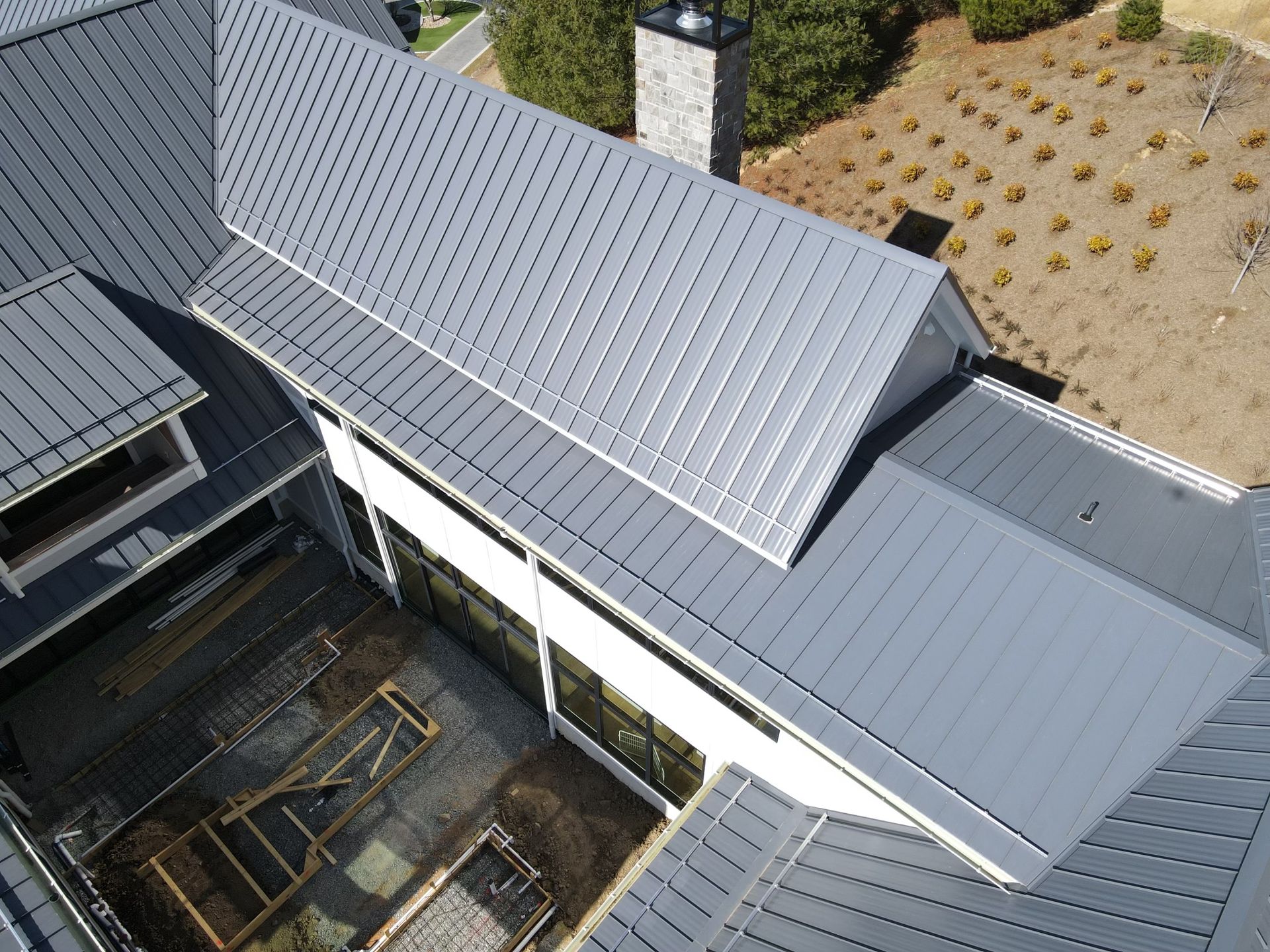 An aerial view of a house with a metal roof
