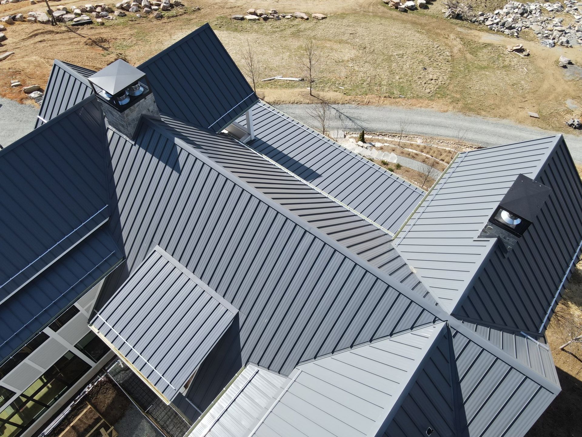 An aerial view of a house with a metal roof