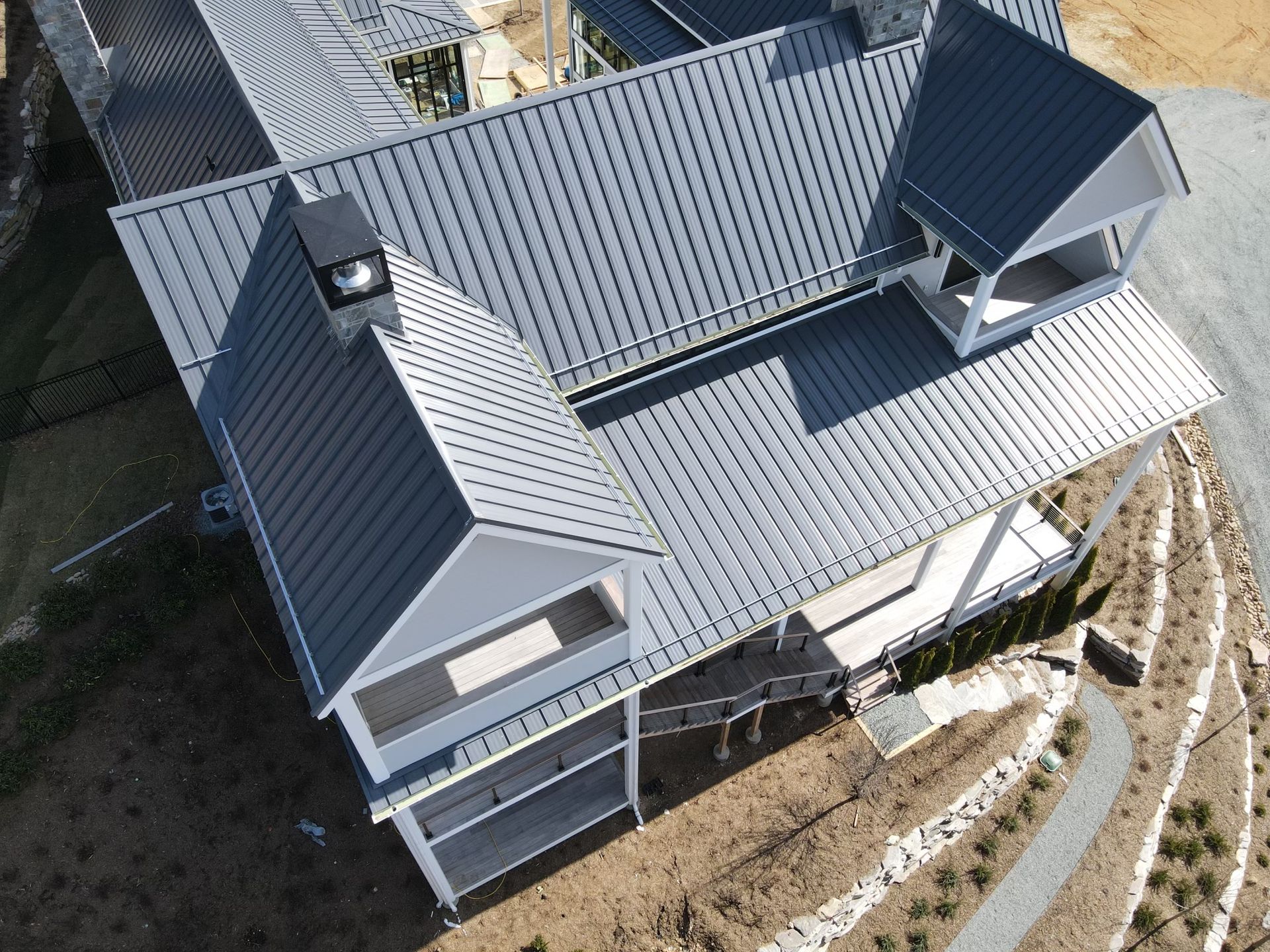 An aerial view of a house with a metal roof.