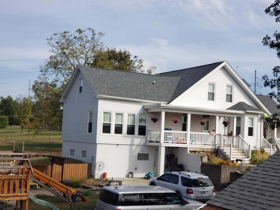 White house with shingle roofing