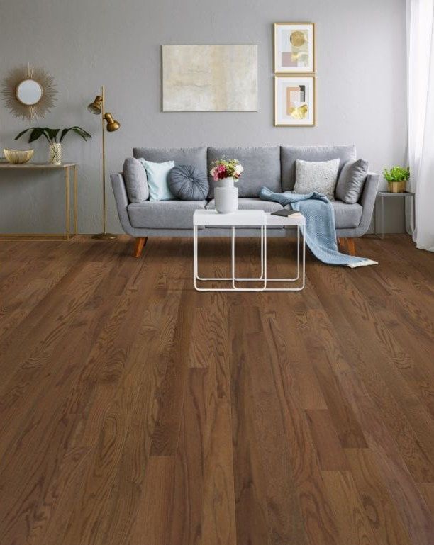 A living room with hardwood floors and a couch.
