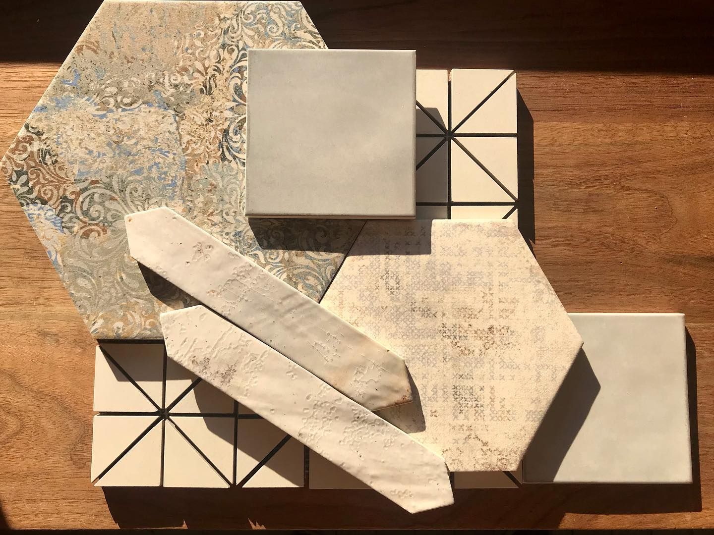 A wooden table with a variety of tiles on it