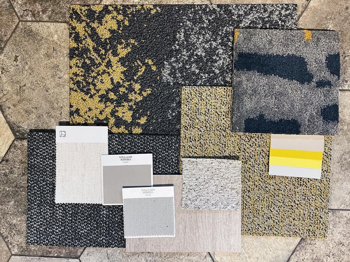 A collage of different types of fabrics on a tiled floor.