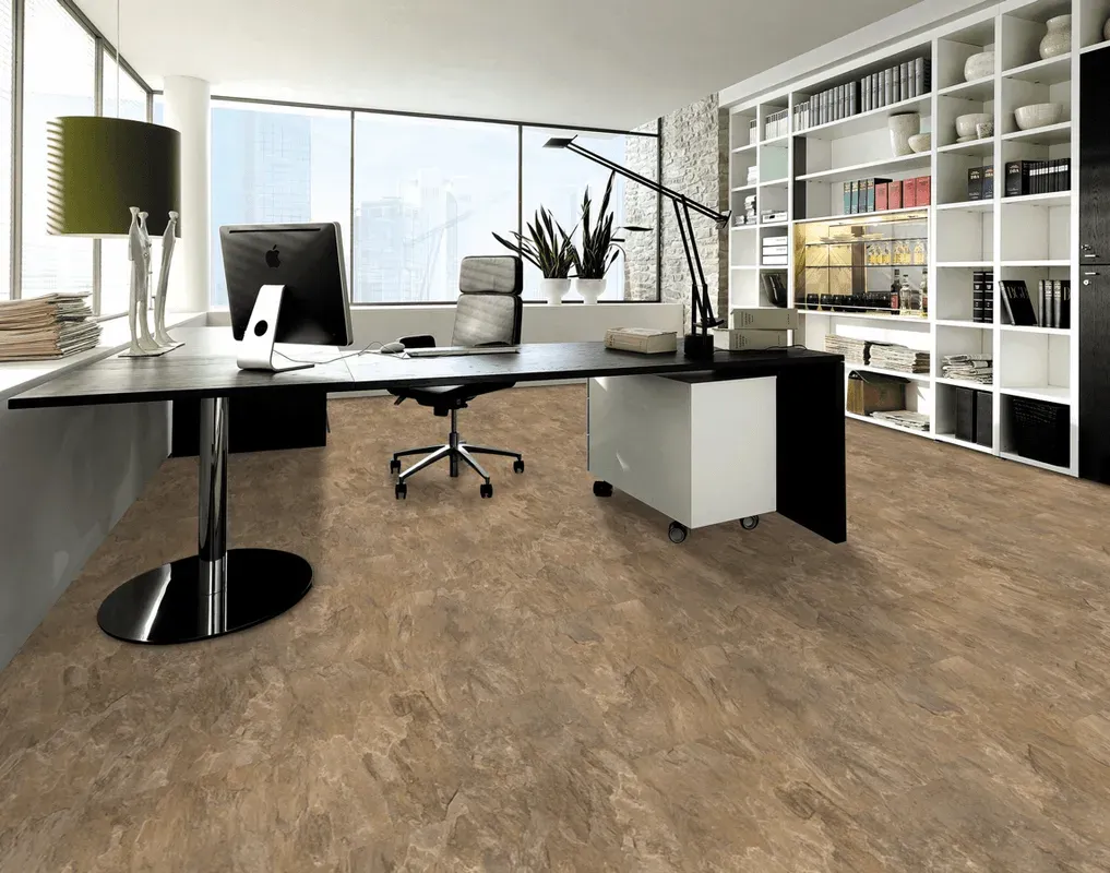 A modern office with a wooden floor and a desk with a computer on it.