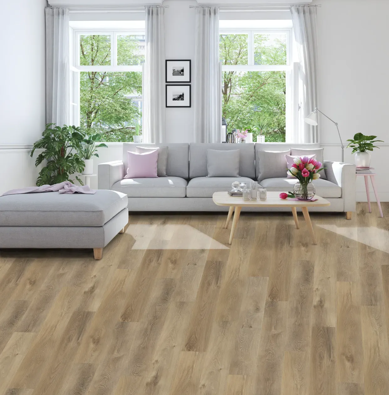 A living room with a couch , ottoman , coffee table and windows.