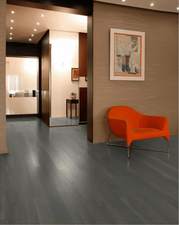 A living room with a chair and a picture on the wall