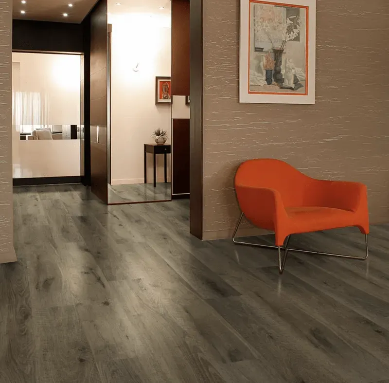 A living room with a chair and a picture on the wall