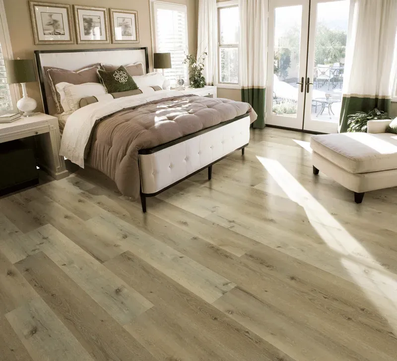 A bedroom with hardwood floors and a large bed