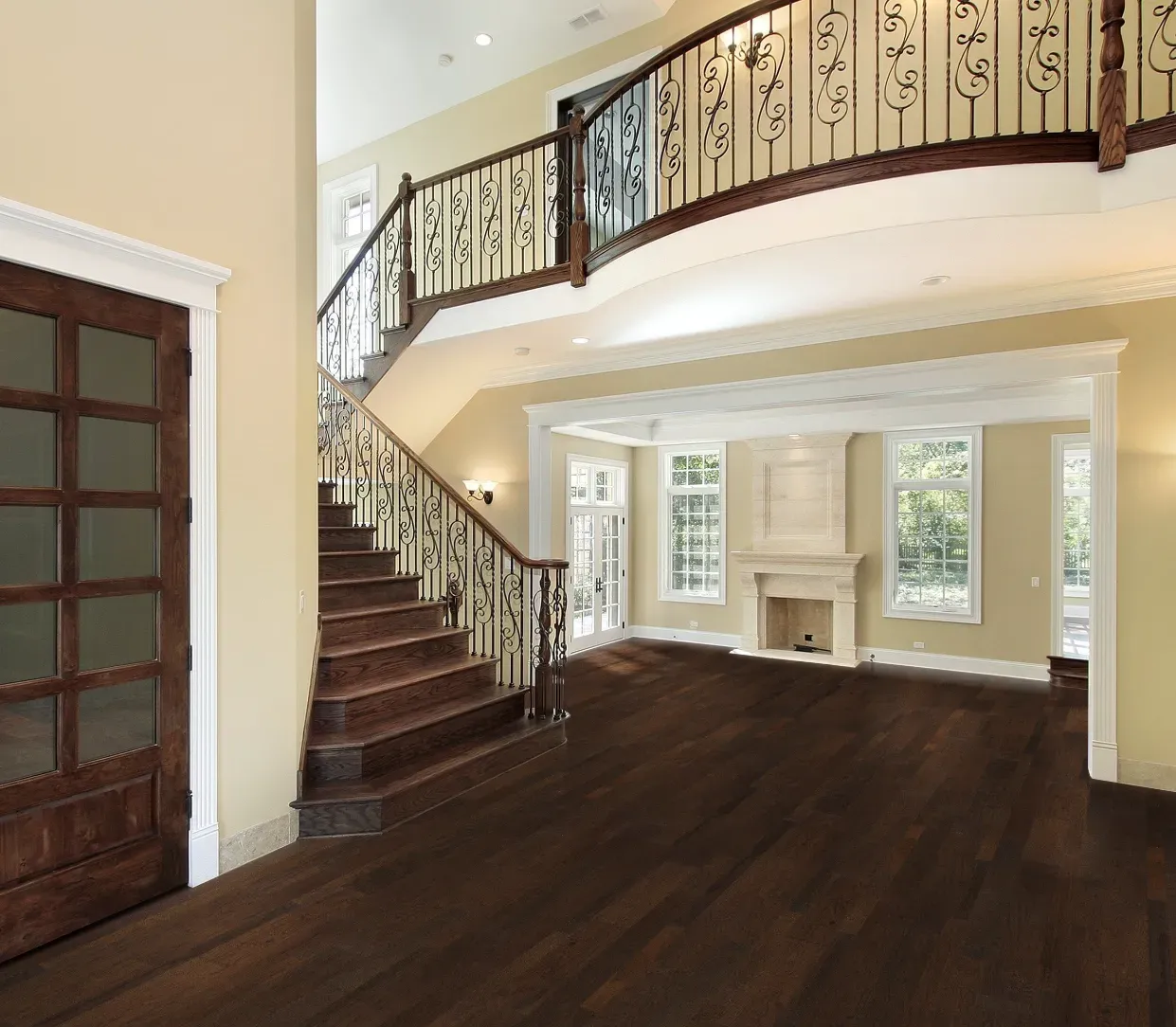 A living room with a staircase and a fireplace