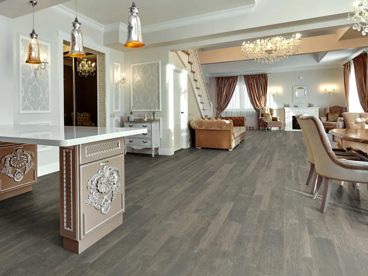 A living room with hardwood floors and a dining room with hardwood floors.