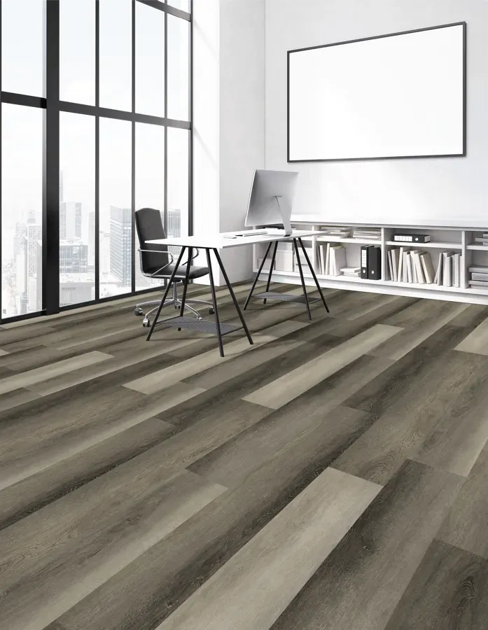 A room with a desk and chair and a large window.