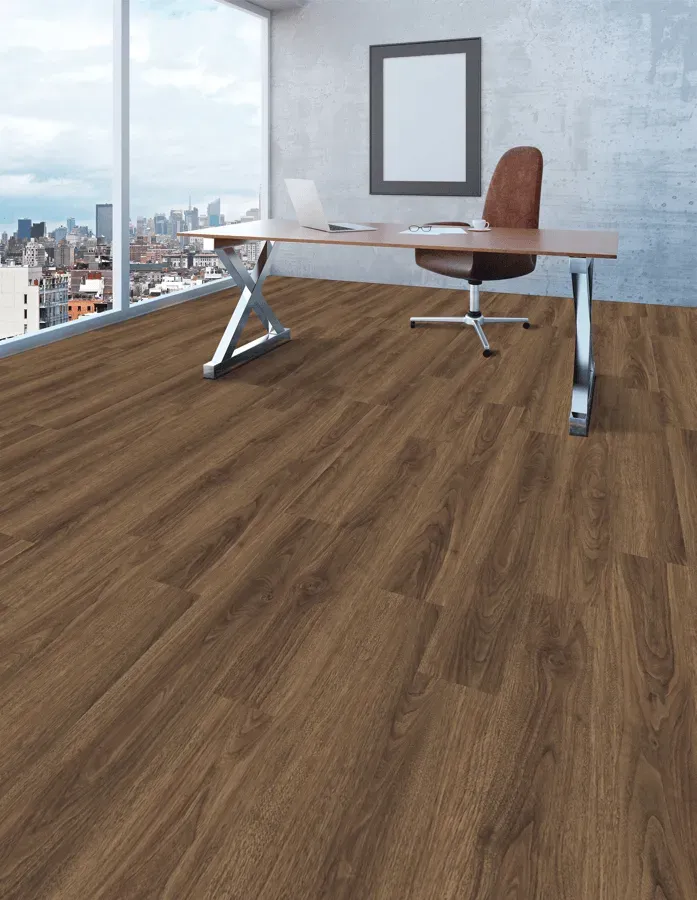 A wooden floor in an office with a desk and chair.