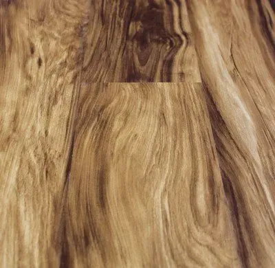 A close up of a wooden floor with a swirl pattern.