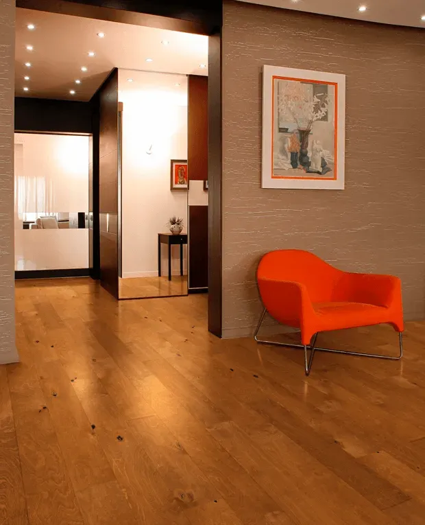 A living room with a chair and a picture on the wall