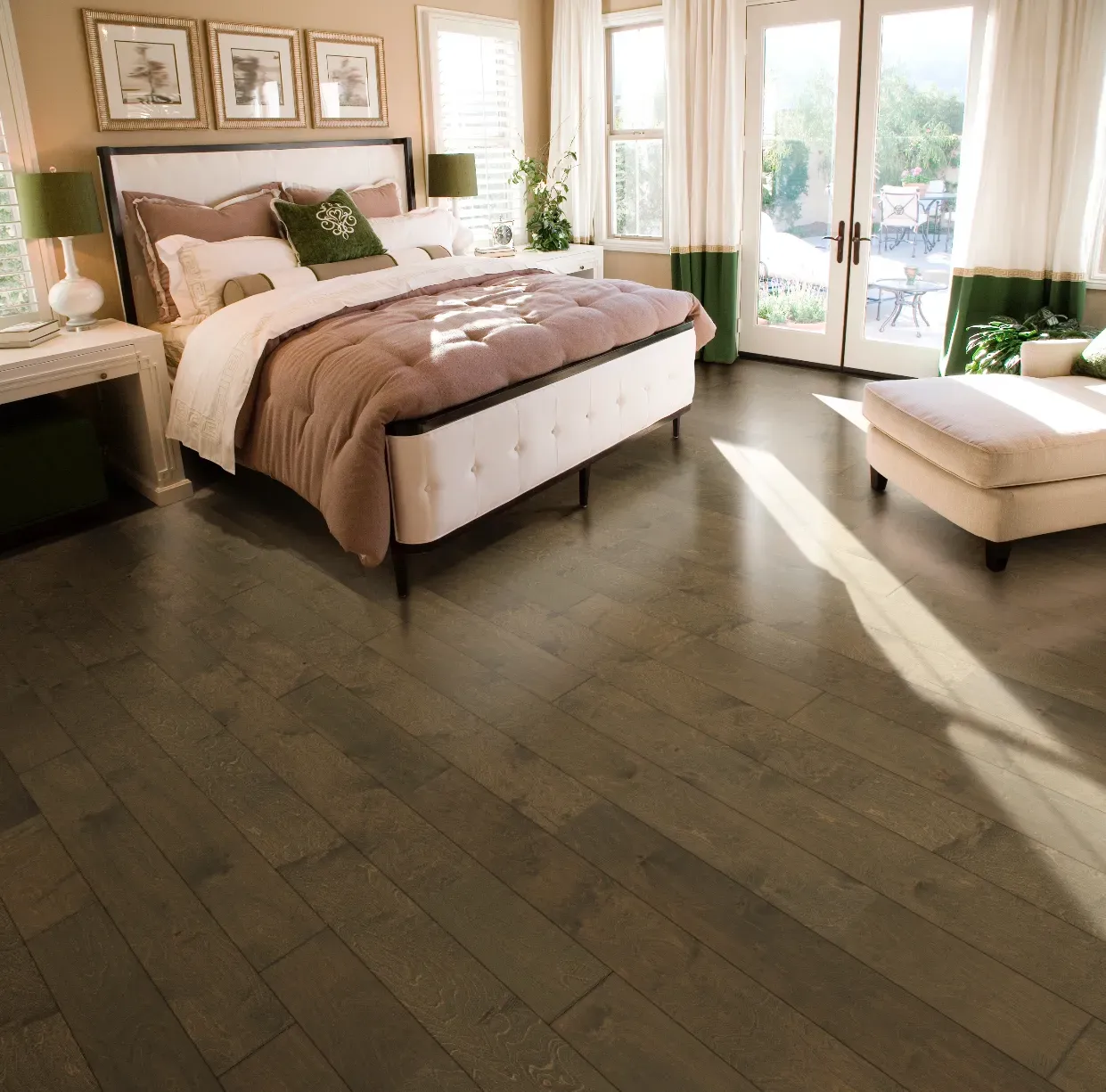 A bedroom with hardwood floors and a large bed