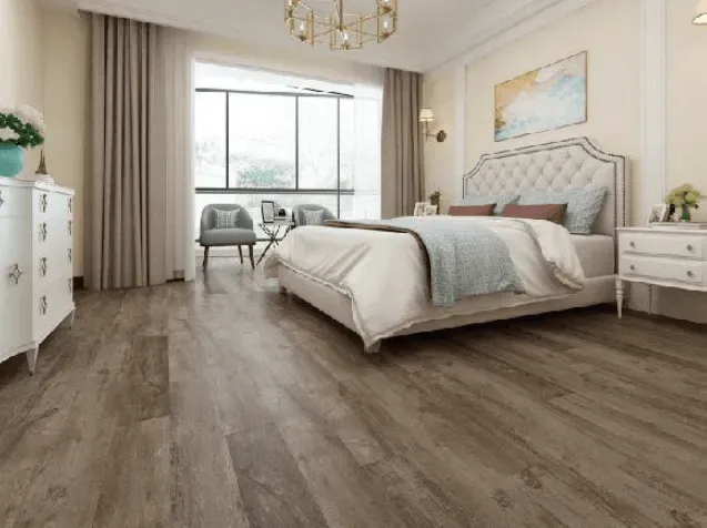 A bedroom with hardwood floors and a large bed.