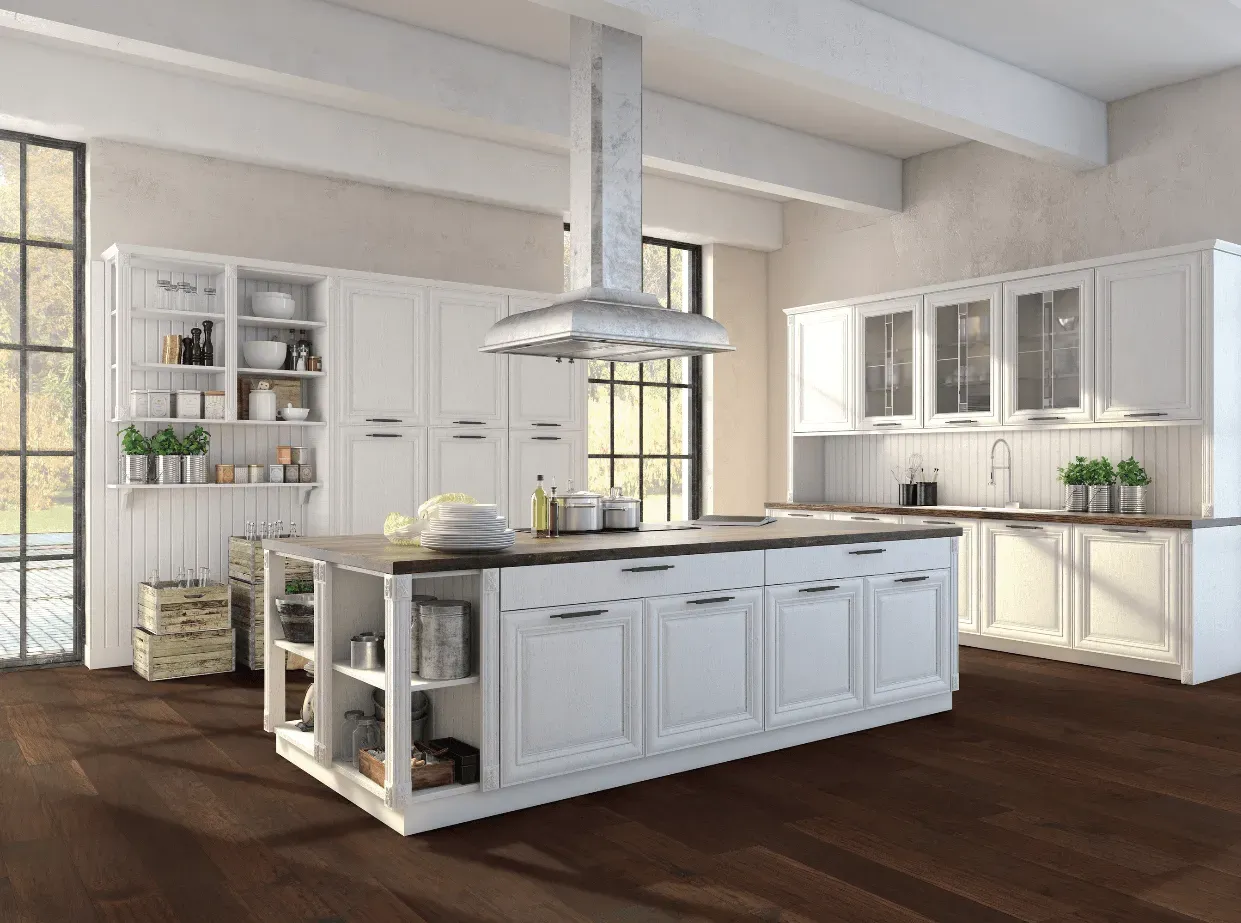 A kitchen with white cabinets and a large island in the middle.