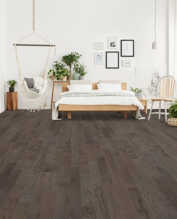 A bedroom with a bed , chair and hammock.