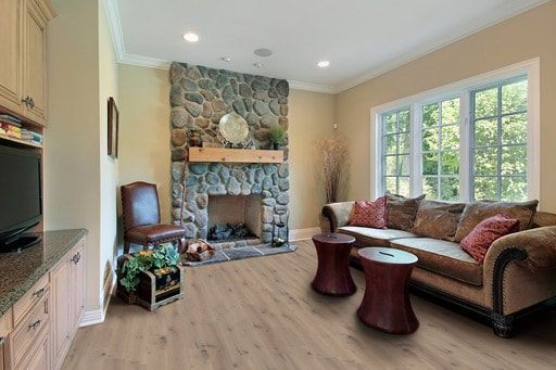 A living room with a couch , fireplace , and television.