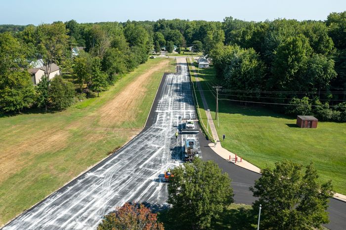 an aerial view of a road that is being paved