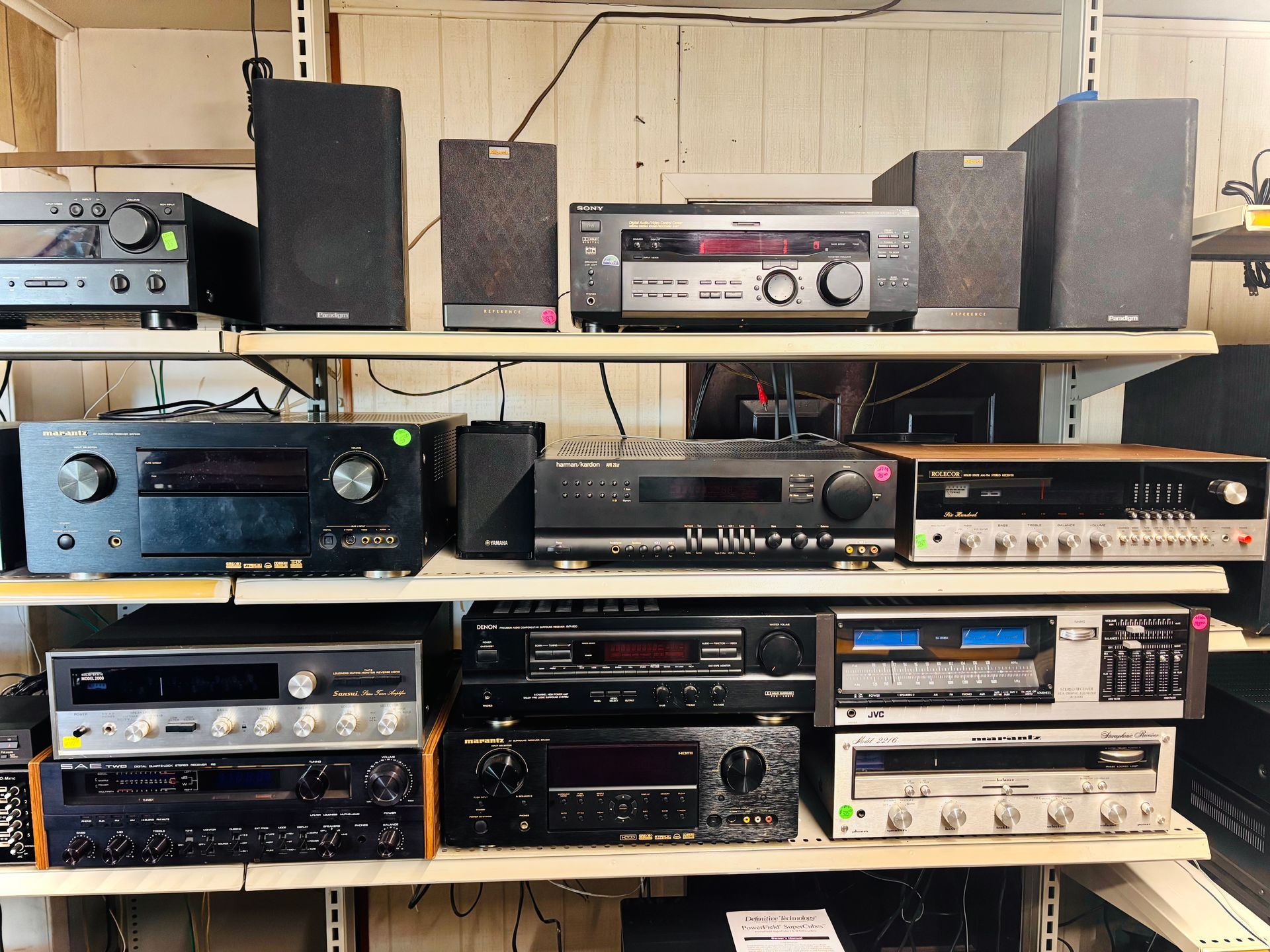 Shelves filled with various vintage stereo receivers and speakers.