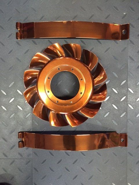 A copper colored object with a hole in the middle