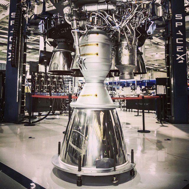 A large rocket engine is in a room with a sign that says usa