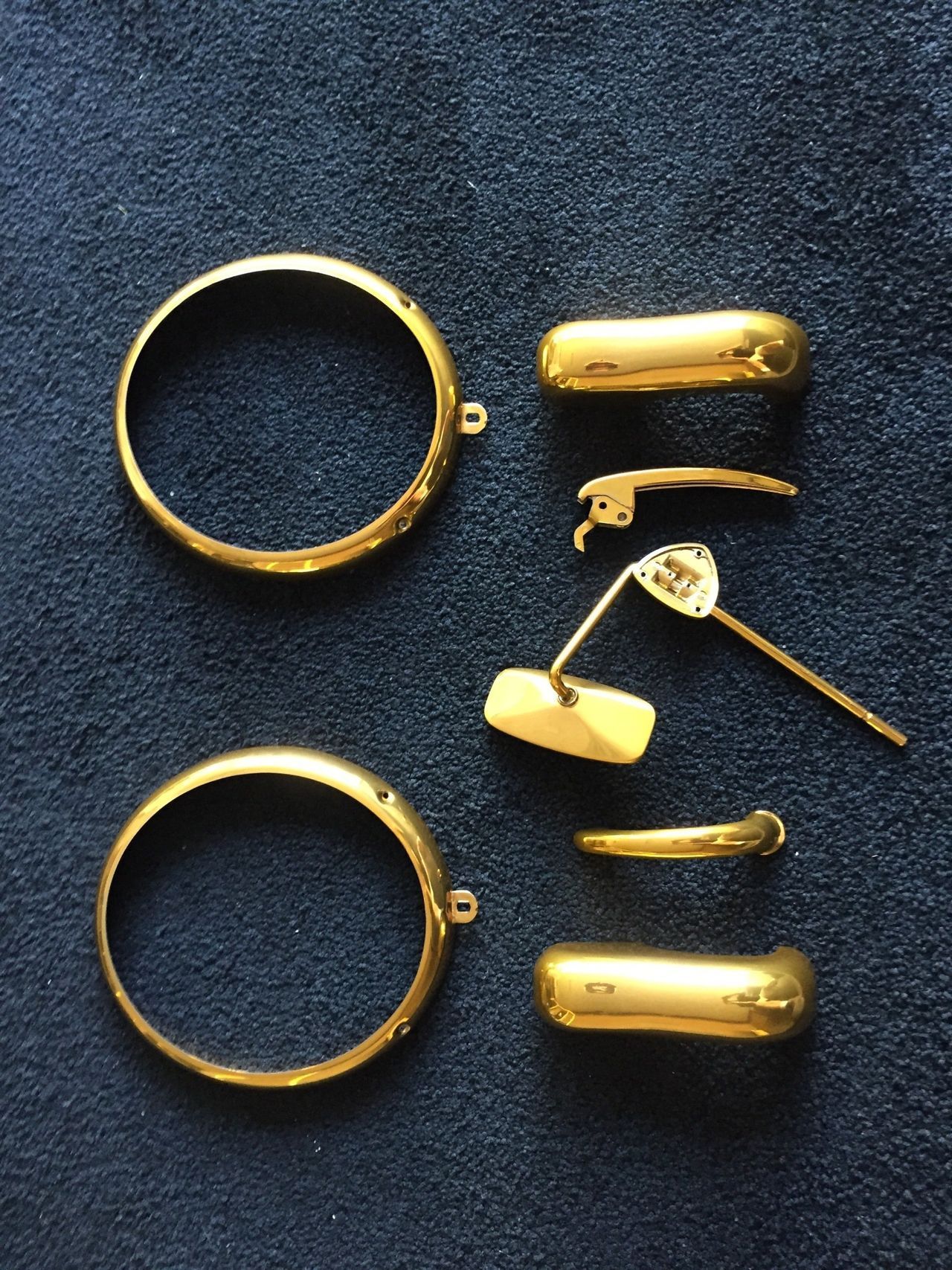 A bunch of gold rings on a blue cloth