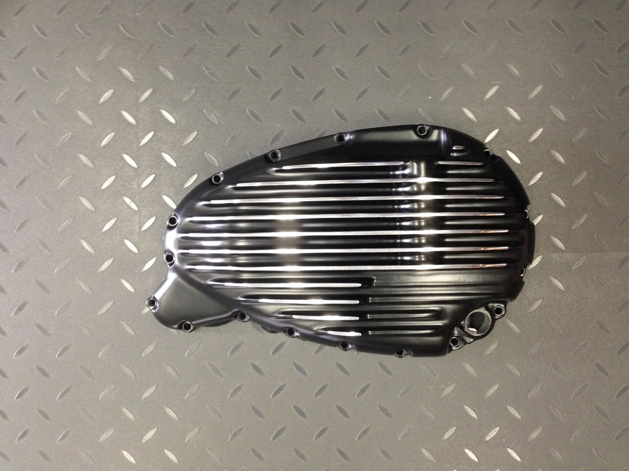 A black metal object is sitting on a metal surface