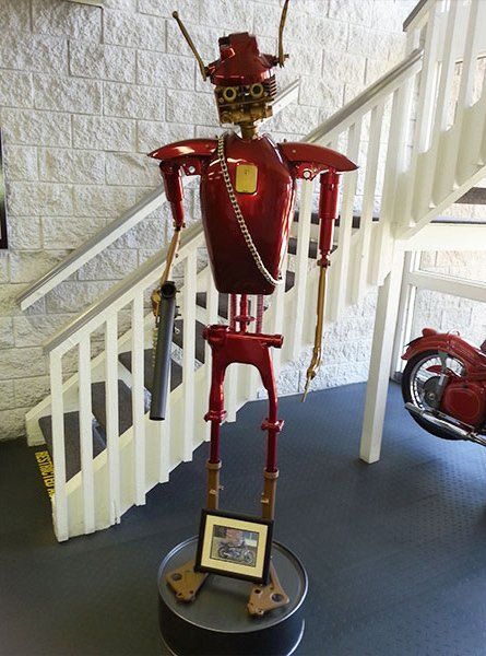 A statue of a robot with a picture of a man on it